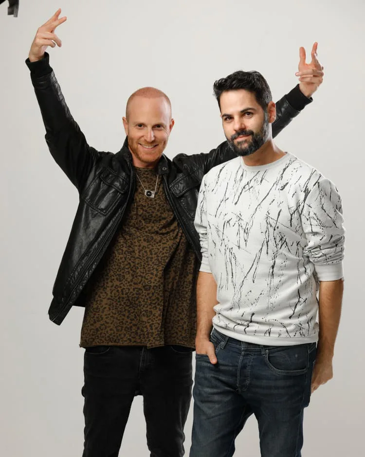 Bonamaze, el dúo de dirección, posando juntos en un estudio fotográfico blanco