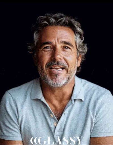 Digital Humans: AI-generated grey-haired man in a polo shirt talking against a black background