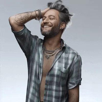 Digital Humans: AI-generated man in a plaid shirt laughing in a studio