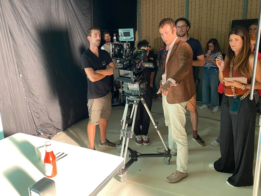 Heinz Tomato Frito, behind the scenes: crew around the camera, a ketchup bottle on the table