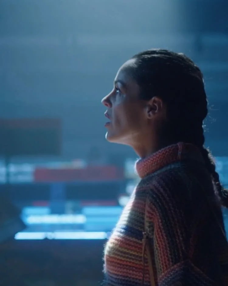 Woman in a striped knit jumper in blue light, from a commercial by Humbert Aparicio