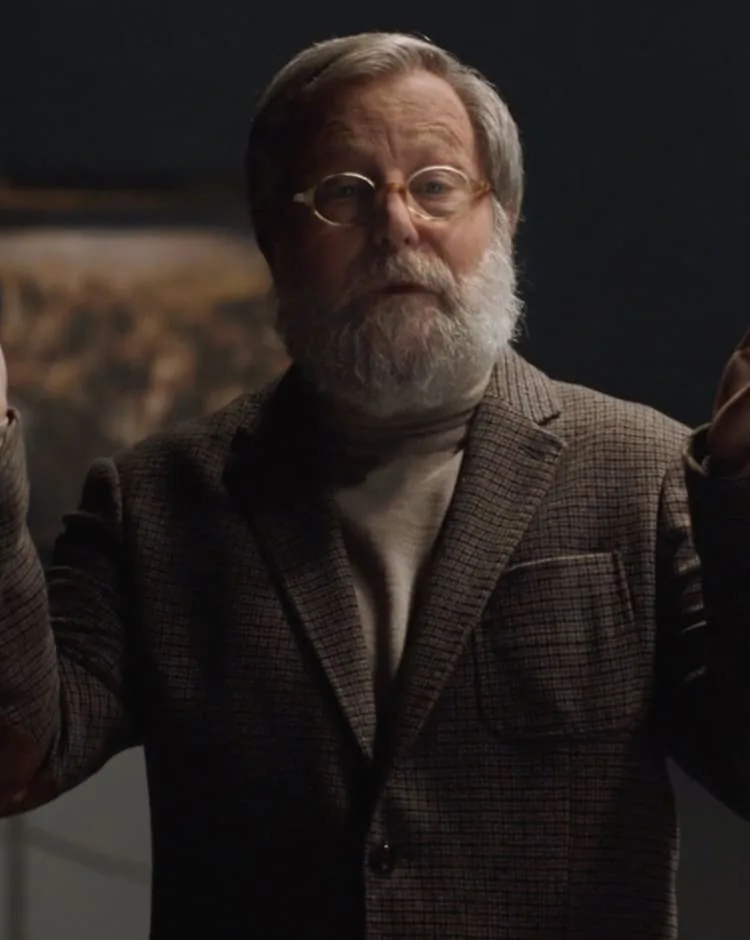 Bearded man in glasses and a tweed jacket speaking, from a commercial by Humbert Aparicio
