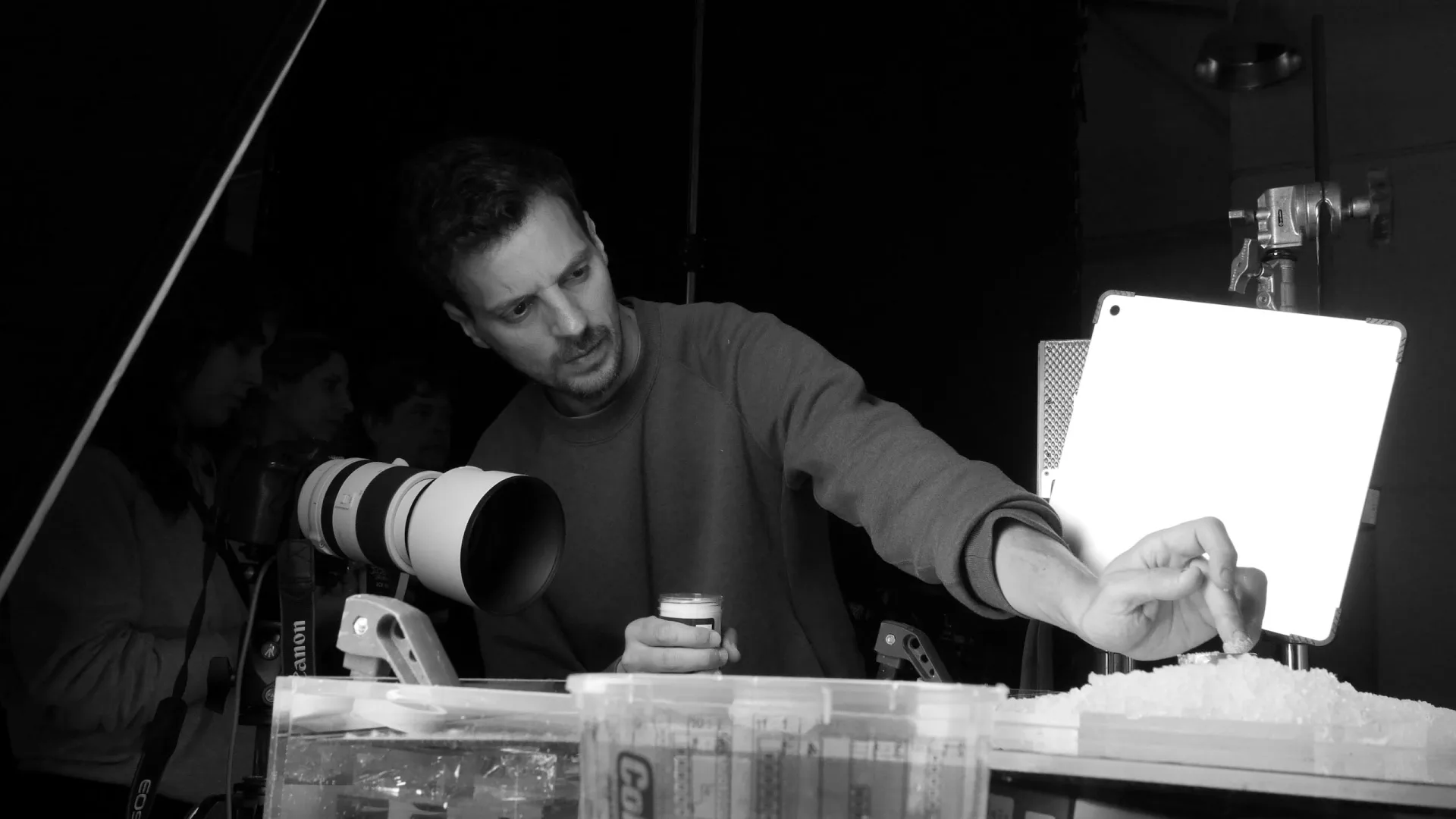 Isdin Hyaluronic making of: technician setting up a product texture shot next to a camera, black and white