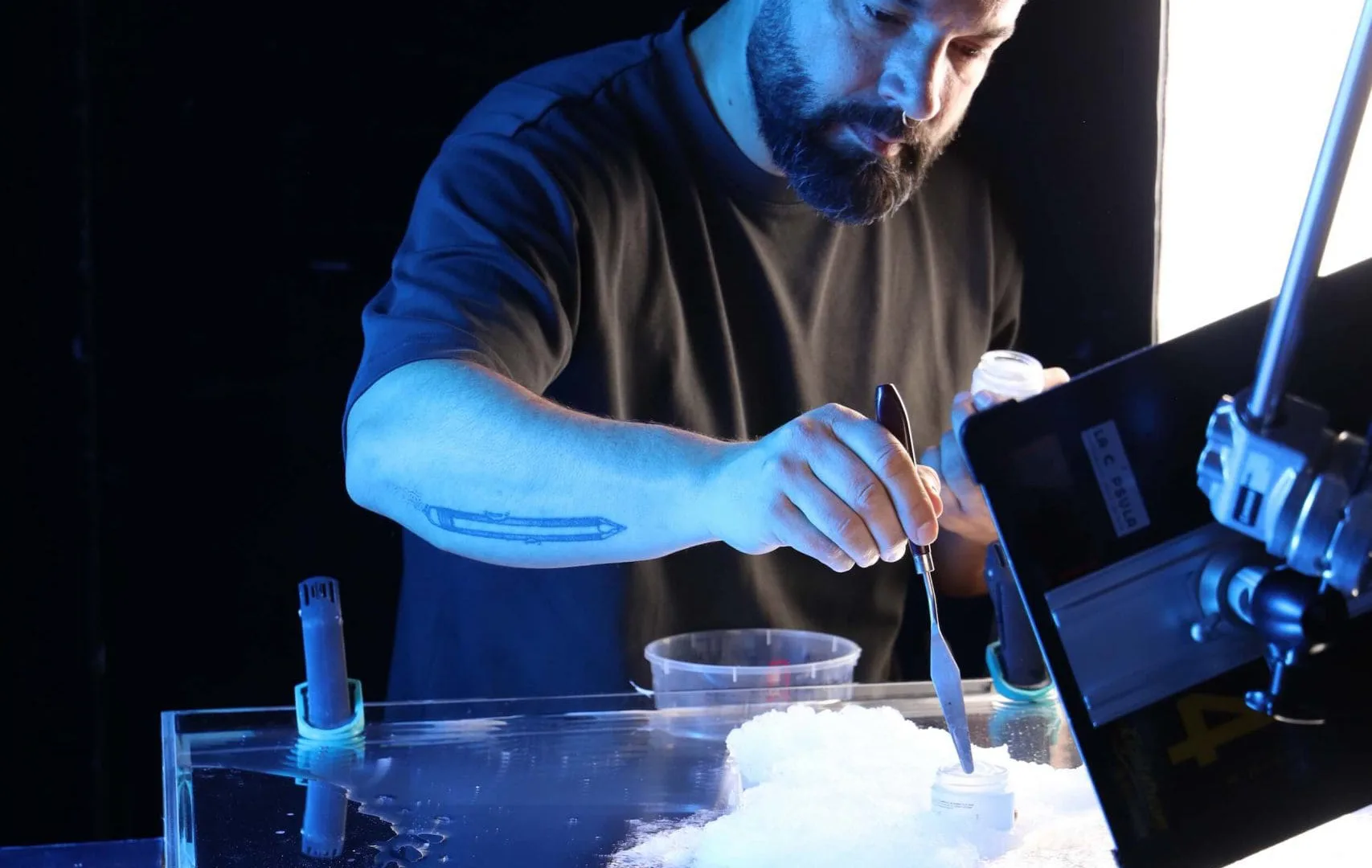 Isdin Hyaluronic making of: crew member preparing a foam texture in a water tank for product shots