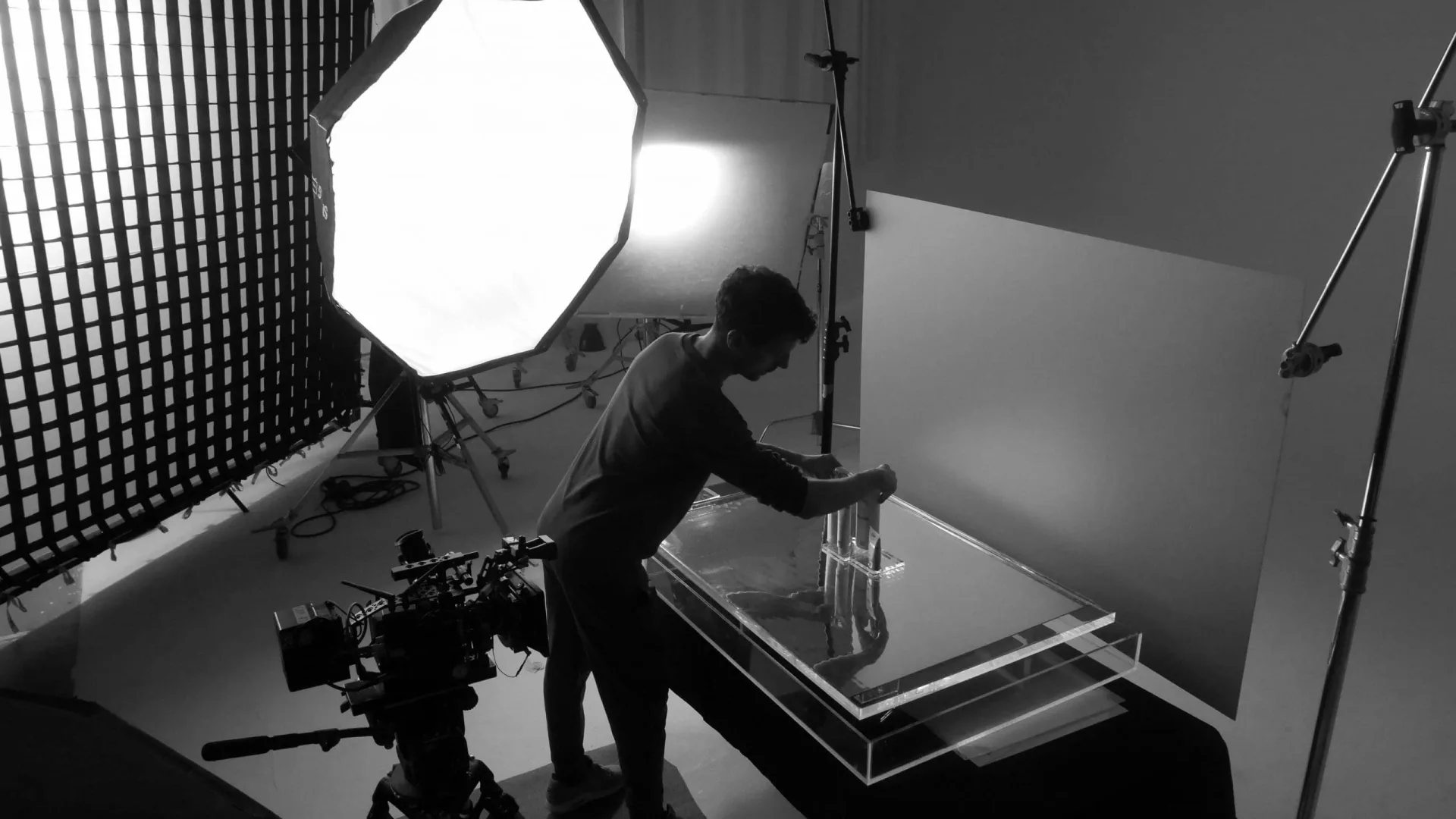 Isdin Ureadin shoot: crew member placing product on an acrylic tabletop under a large softbox