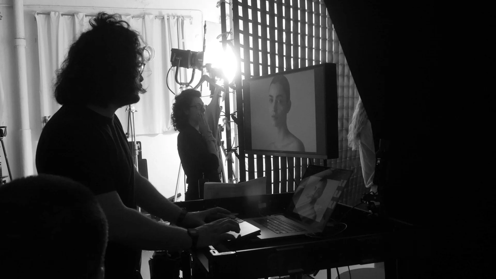 Isdin Ureadin shoot: technician at a laptop beside a monitor showing a model's portrait