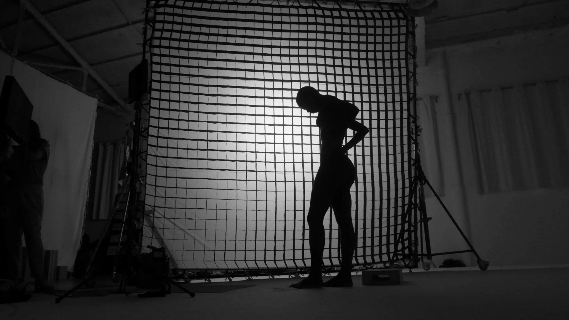 Isdin Ureadin shoot: model in silhouette, backlit against a large grid diffusion frame