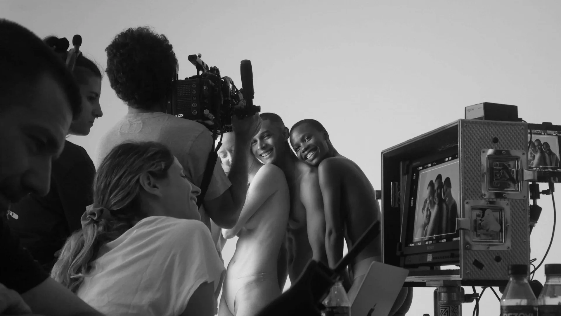 Isdin Ureadin shoot: crew around the camera as two smiling models pose beside the monitor