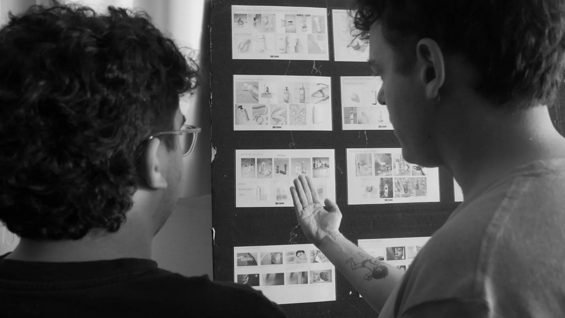 Isdin Ureadin shoot: two crew members reviewing the storyboard pinned to a board