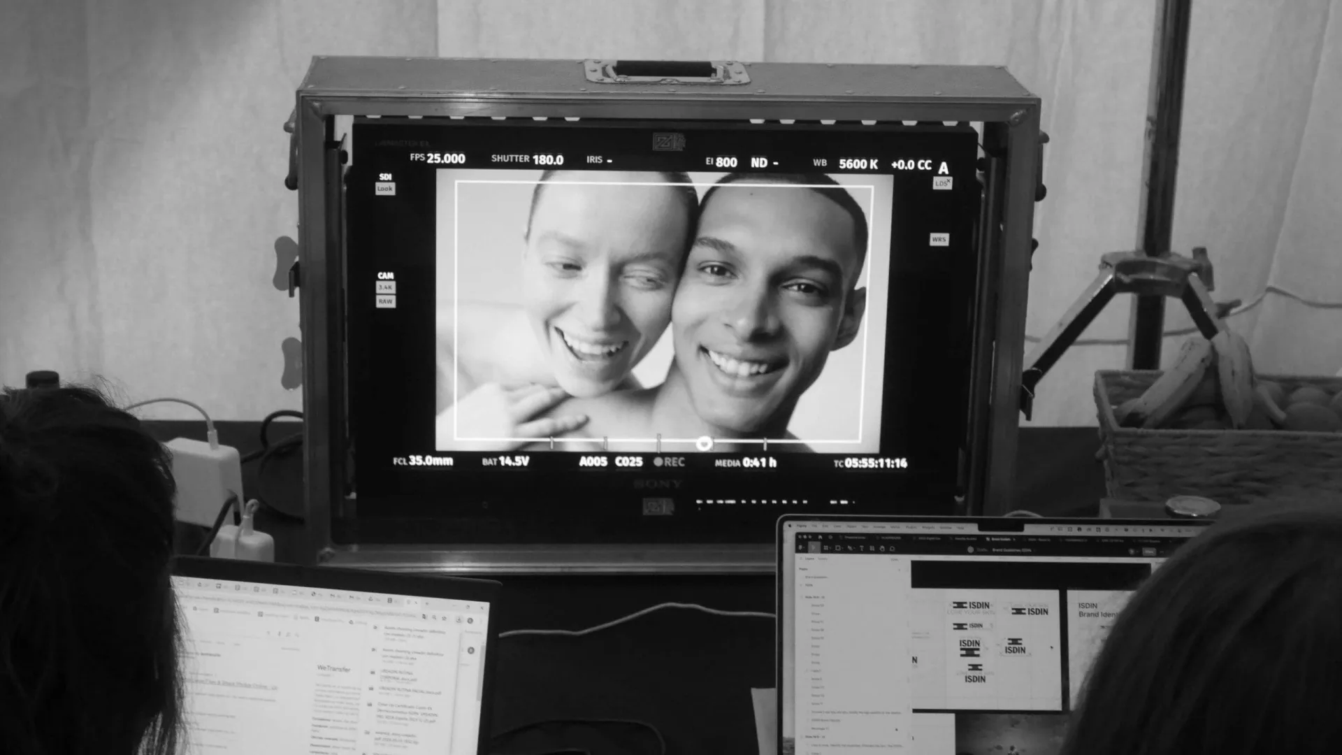 Isdin Ureadin shoot: team at their laptops below a monitor showing two smiling models