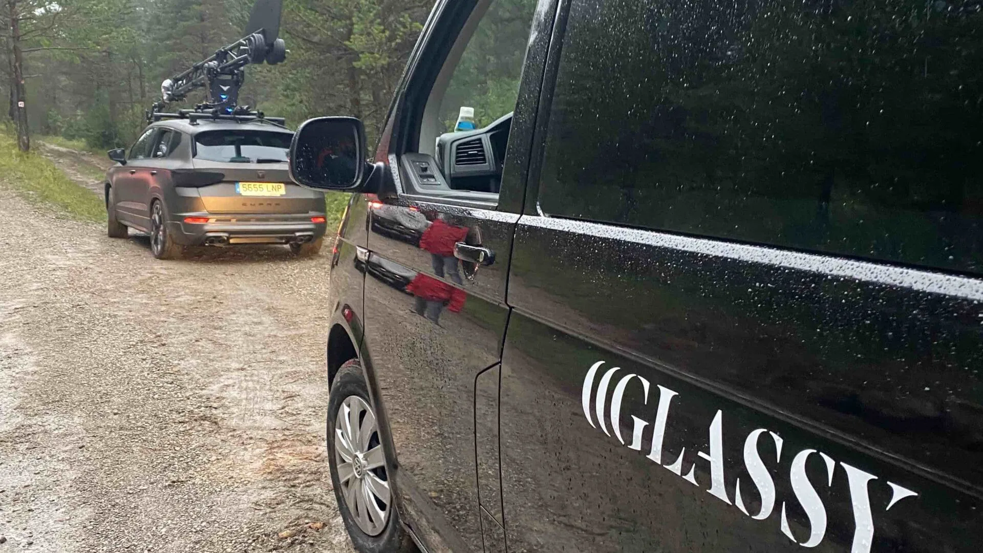 Jeep shoot: Glassy van parked behind the camera car on a forest track