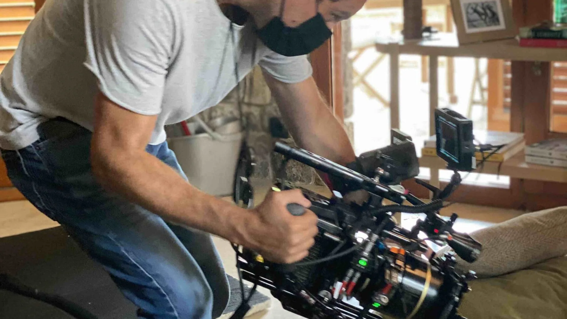 Jeep shoot: camera operator filming a low handheld shot inside a house