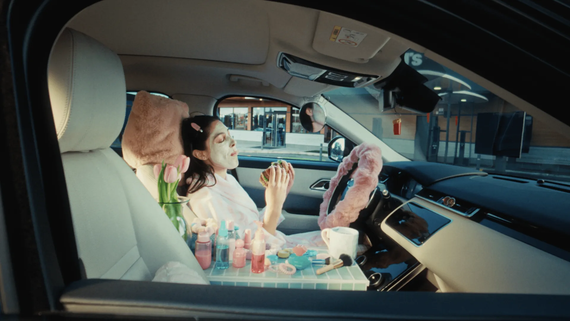 McDonald’s, frame: woman in pyjamas inside the car turned into a bedroom