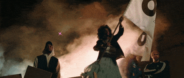 Frame from OCB Rolling Revolution: a woman waves a white flag through smoke at night