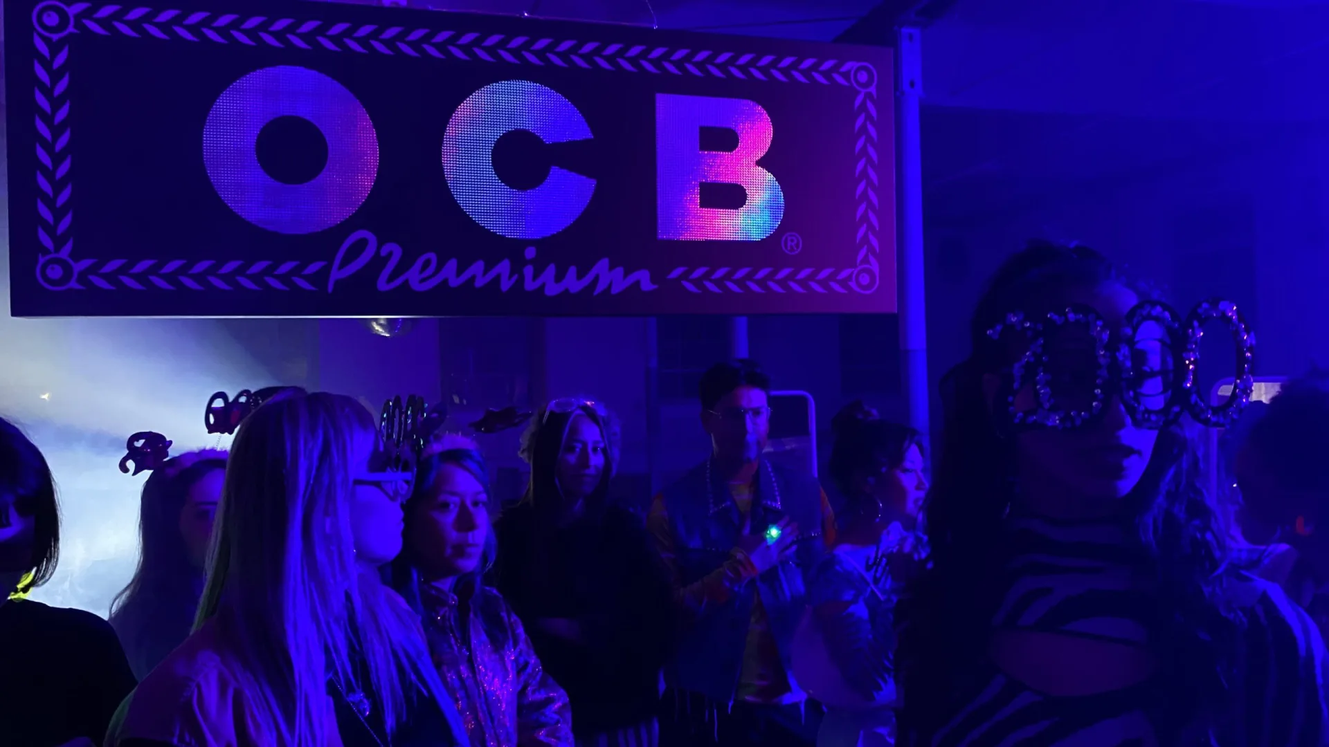 OCB Rolling Revolution shoot: party scene under an OCB Premium sign