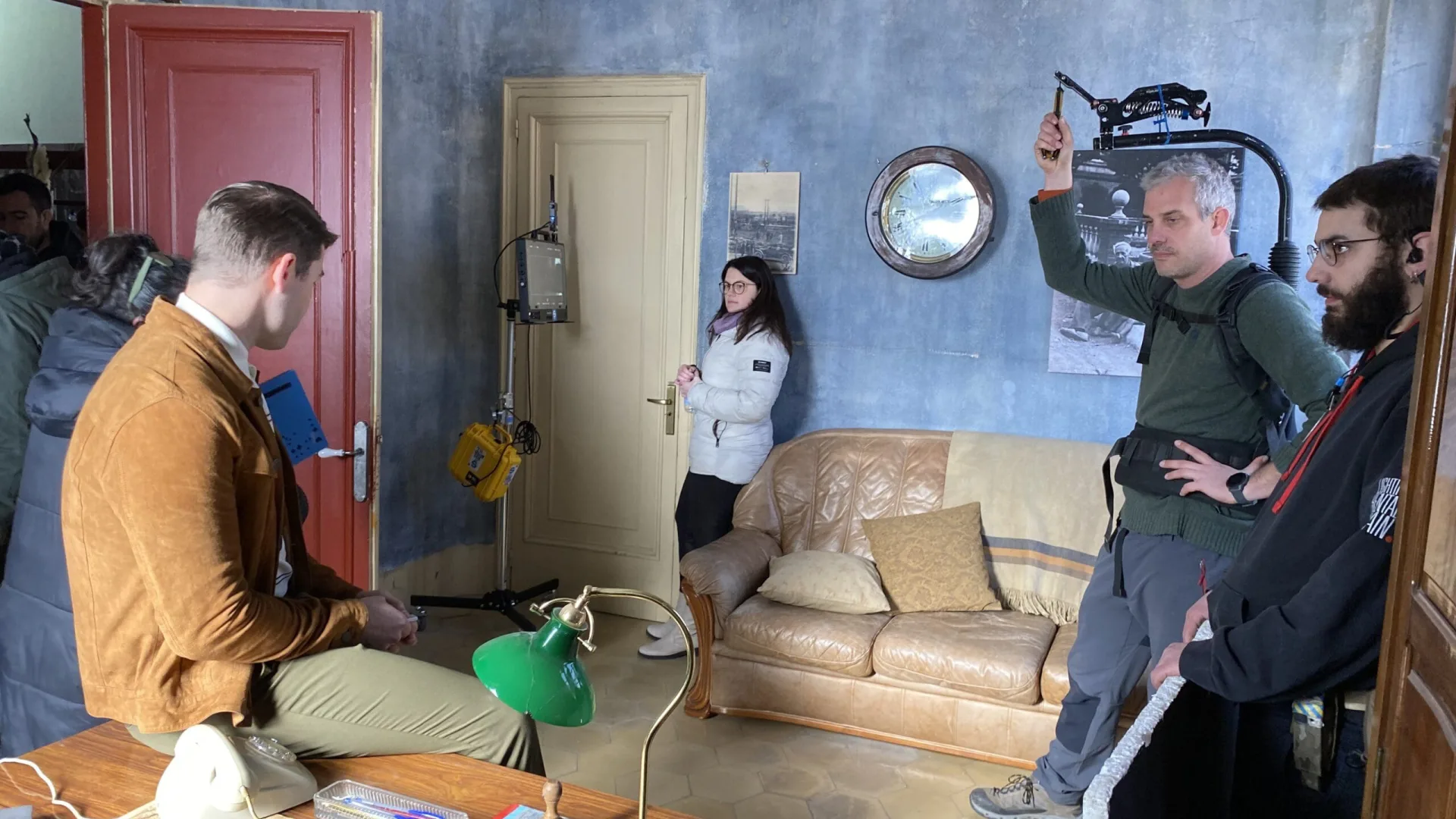 OCB Rolling Revolution shoot: camera operator filming an actor in a period office set