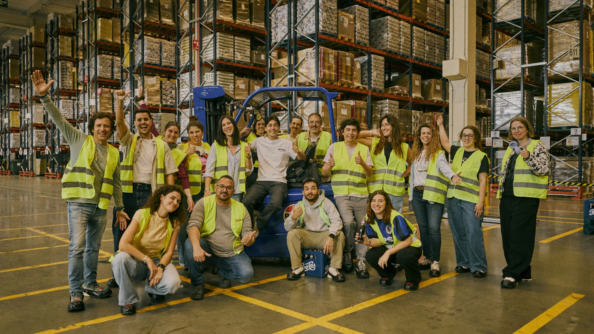 Pepsi x Nil Ojeda shoot: the crew and warehouse team posing around a Pepsi forklift