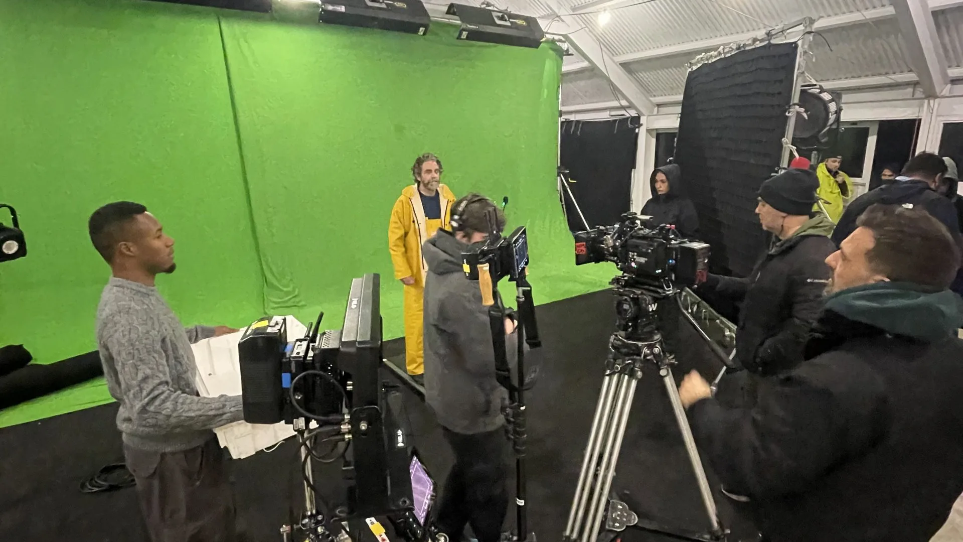 Pescanova shoot: actor in yellow oilskins on a green screen set with the camera crew