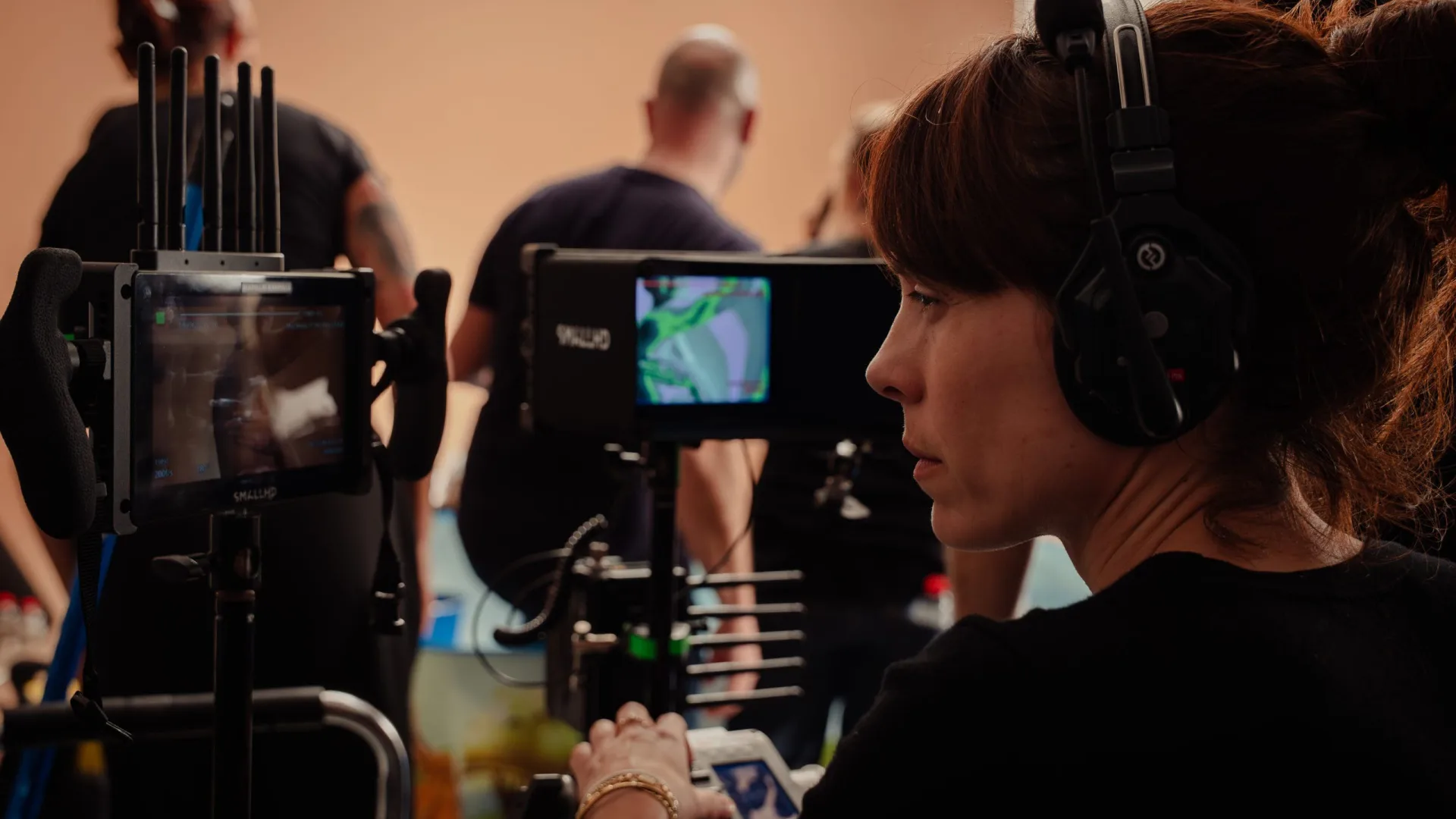 Sanex UAP shoot: crew member with headset watching the monitors on set