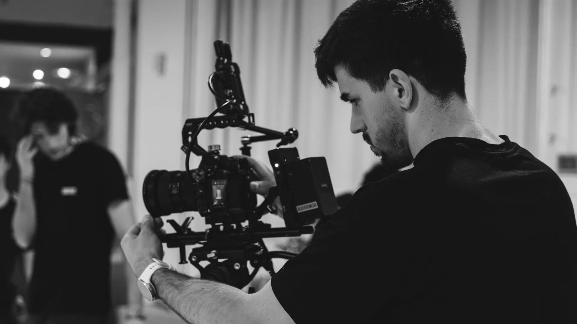 Sanex UAP making of: camera operator with a handheld rig, black and white