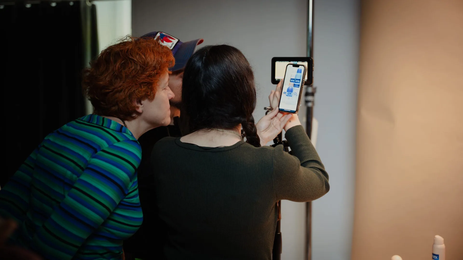 Sanex UAP making of: two crew members reviewing material on a phone