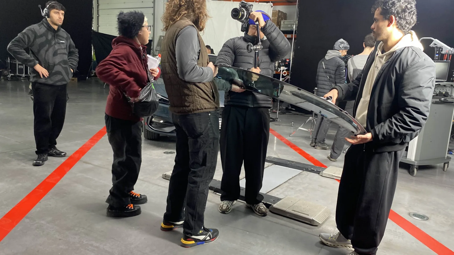 Seat Connect making of: crew handling a curved glass panel between takes in the studio