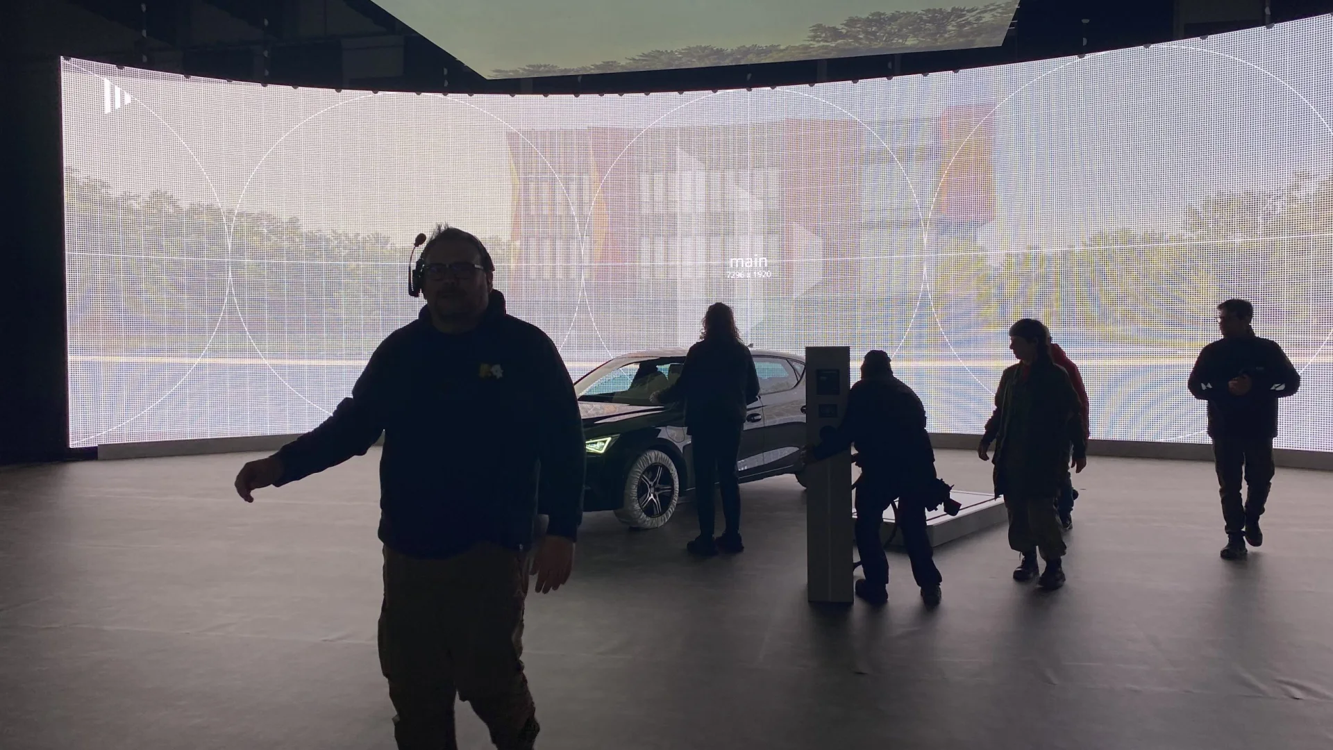 Seat Connect shoot: crew walking through the dim LED volume around the car and charger