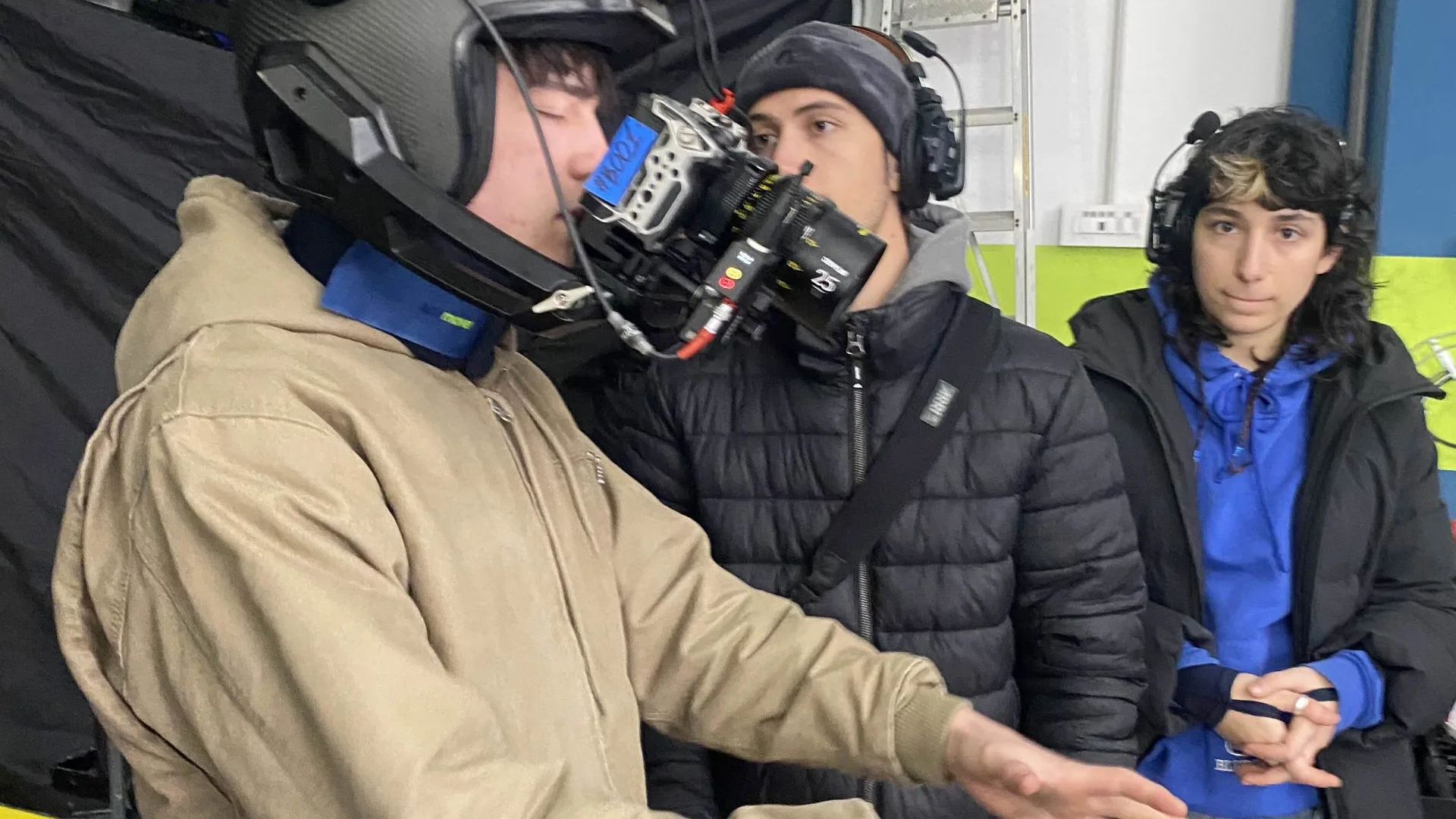 Seat Connect shoot: actor testing a helmet camera rig while the crew looks on