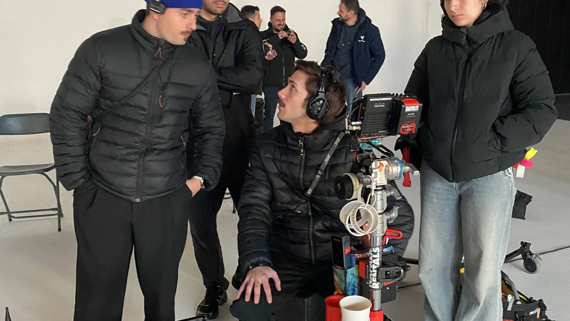 Seat Connect shoot: crew with headsets gathered around the camera on the studio floor