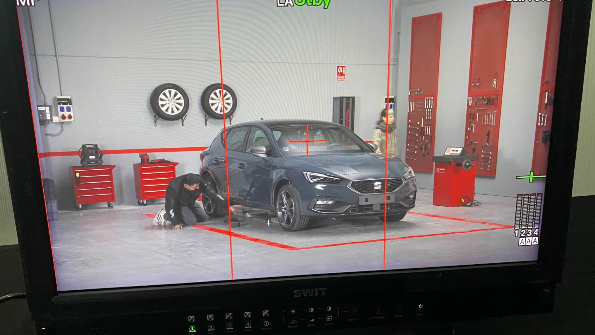 Seat Connect shoot: on-set monitor framing the Seat León and two actors in the workshop set
