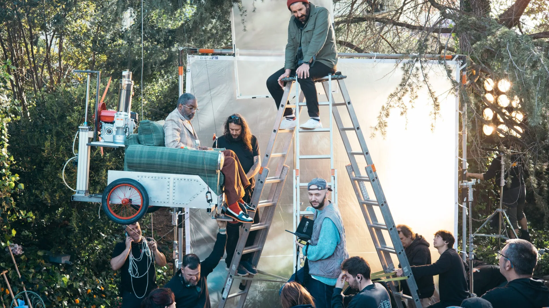 Shredded Wheat shoot: crew on ladders rigging the armchair vehicle with the actor seated