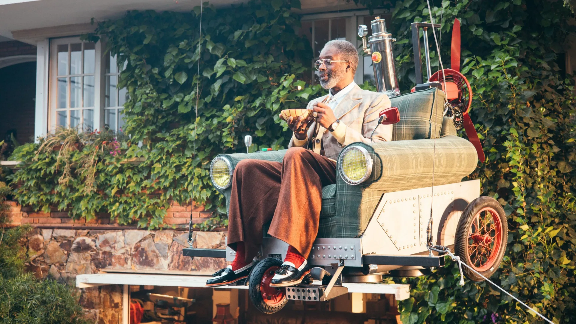 Shredded Wheat shoot: the actor airborne in the flying armchair, suspended on wires above the garden