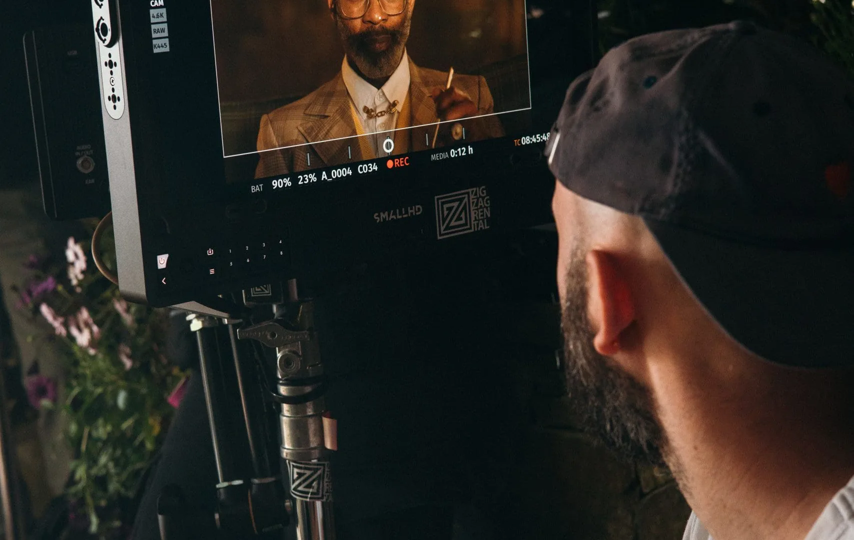 Shredded Wheat shoot: crew member watching the actor in a tweed suit framed on the monitor