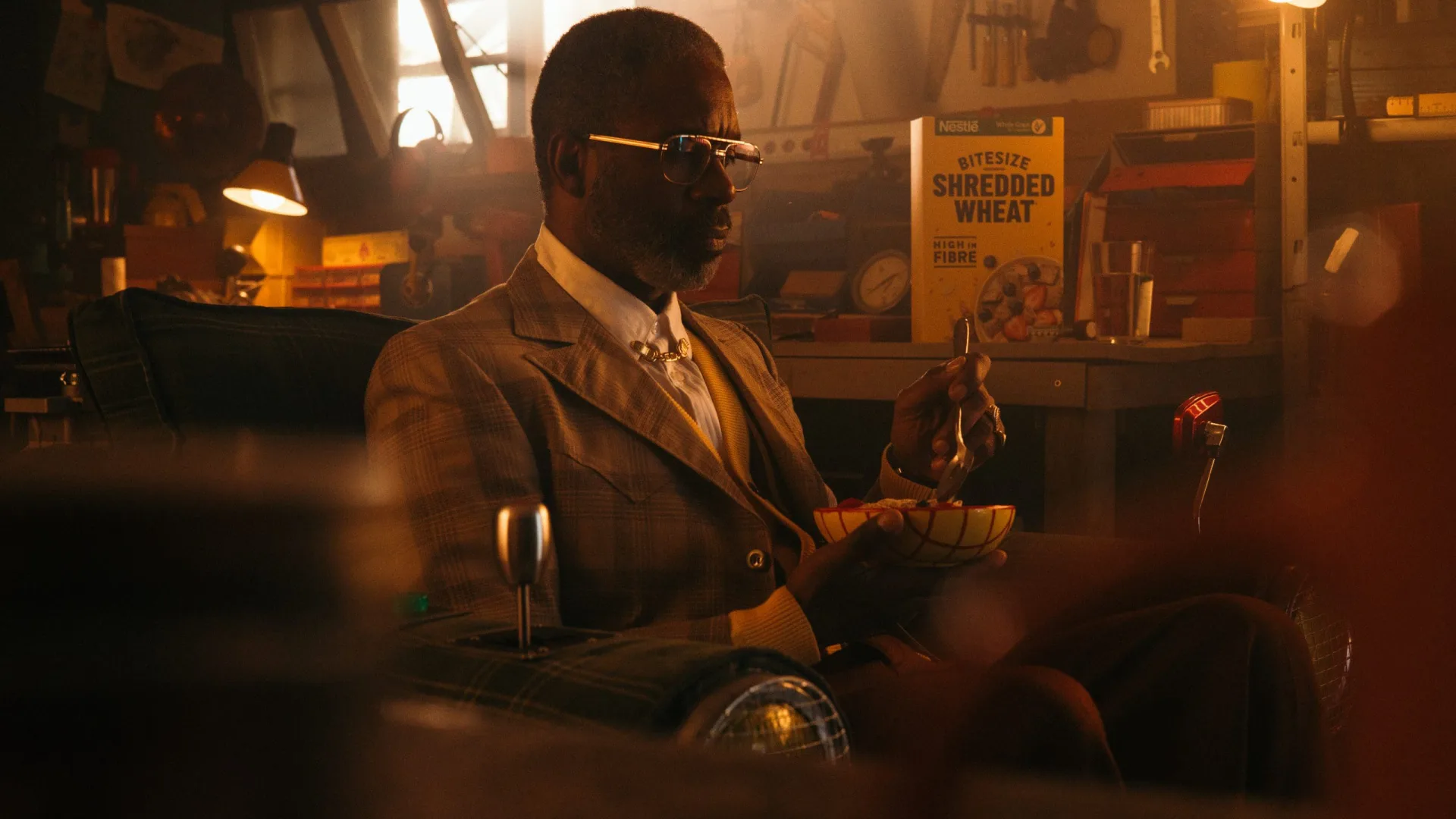 Shredded Wheat spot: man in a tweed suit eating cereal in his armchair in a workshop