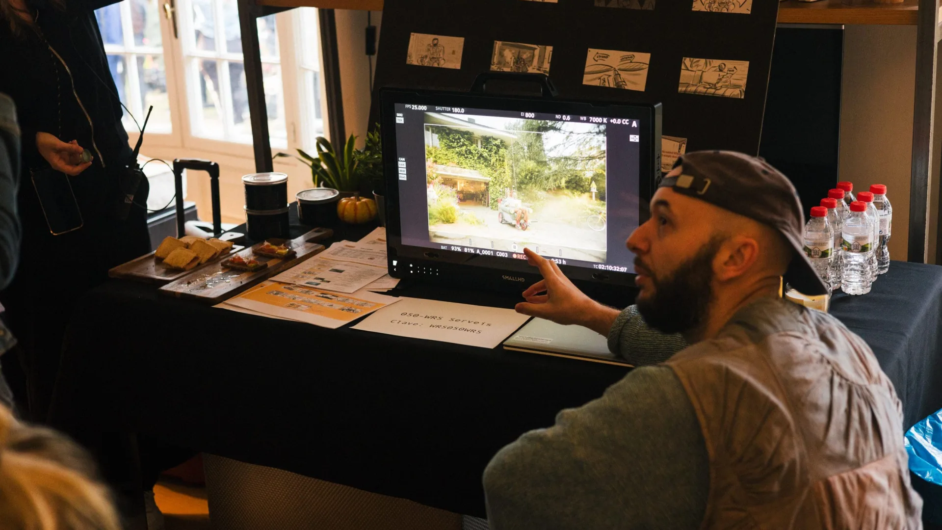 Shredded Wheat shoot: crew member pointing at the monitor, with the storyboard pinned behind