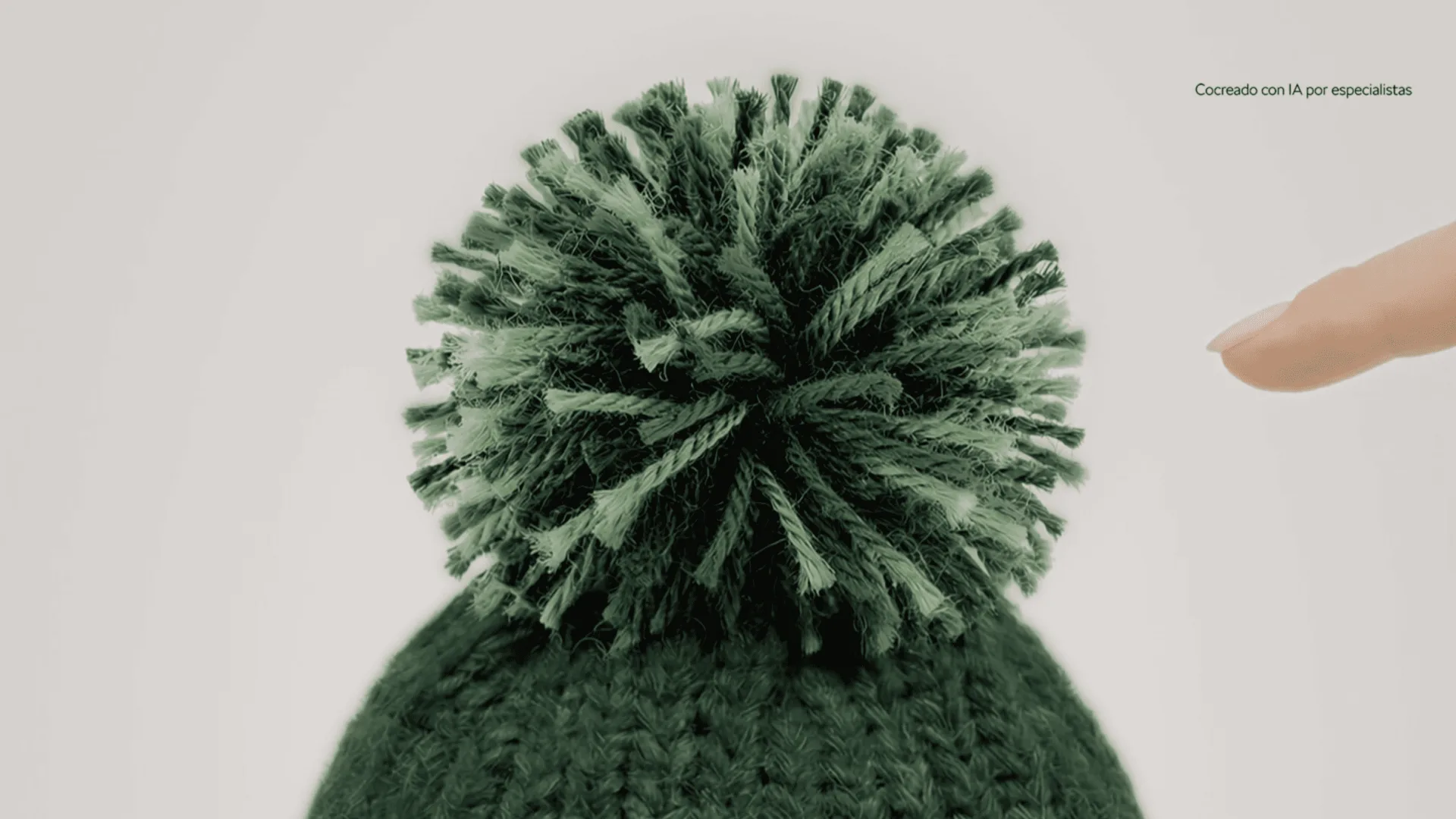 Škoda, AI-generated frame: a finger touching a green knitted pompom