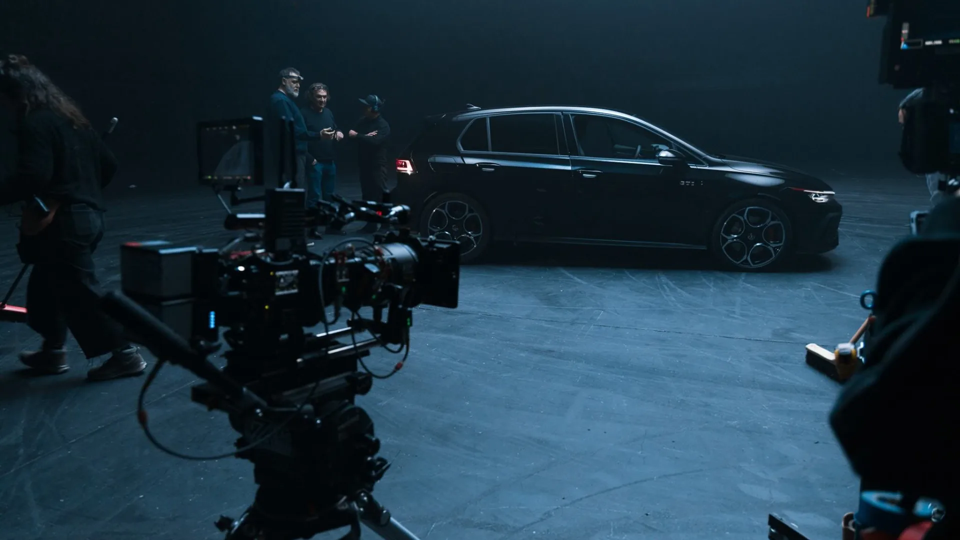 Volkswagen Golf GTI shoot: cameras ready while the crew talks beside the black car