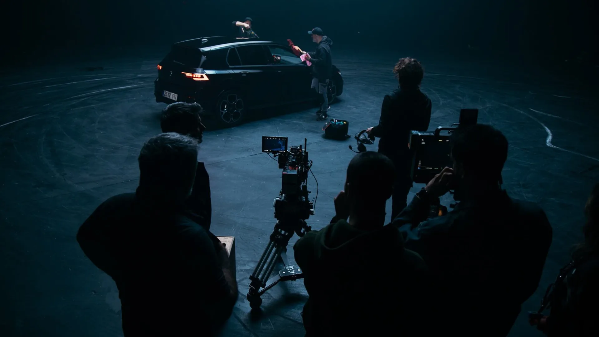 Volkswagen Golf GTI shoot: crew silhouettes behind the cameras as the car is prepped