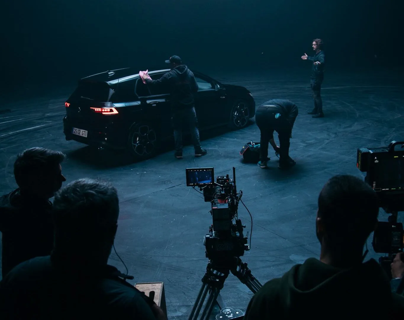 Volkswagen Golf GTI shoot: crew prepares the car on a drift-marked studio floor