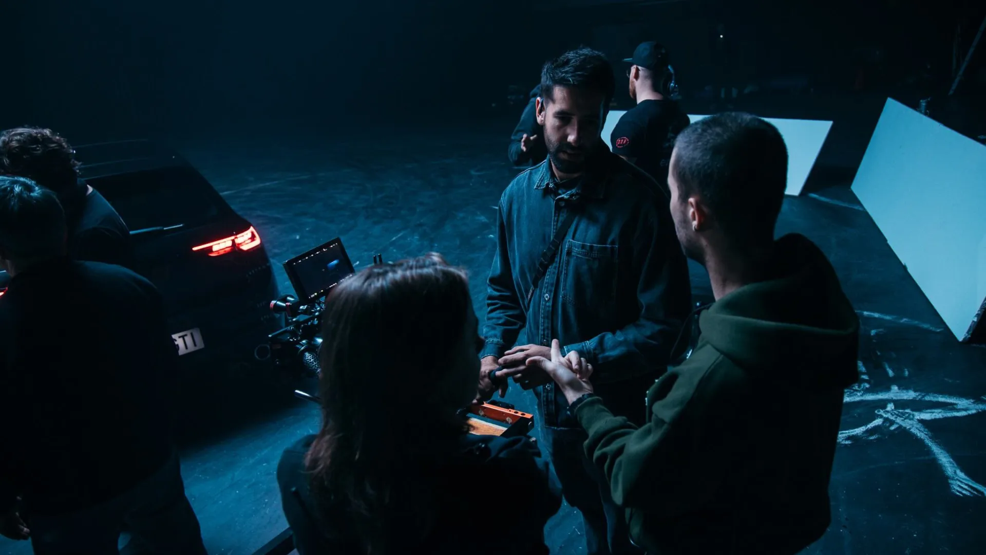 Volkswagen Golf GTI shoot: crew members talking by the monitor next to the car