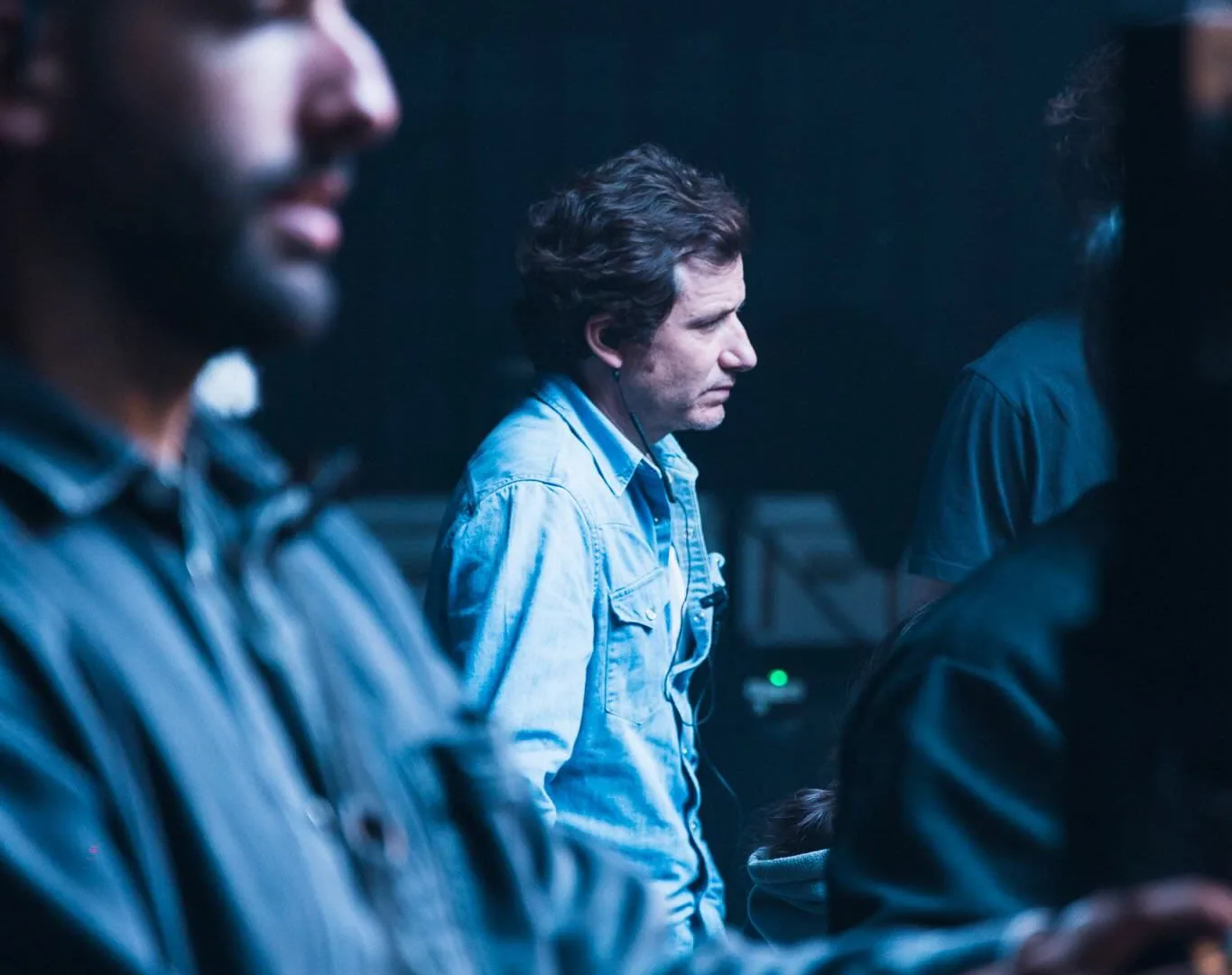 Volkswagen Golf GTI making of: crew members watching the take in a blue-lit studio
