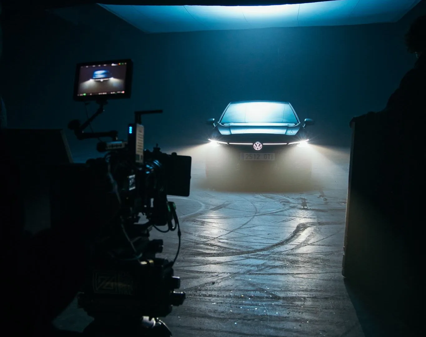 Volkswagen Golf GTI shoot: camera facing the car, headlights on, through haze under a large softbox